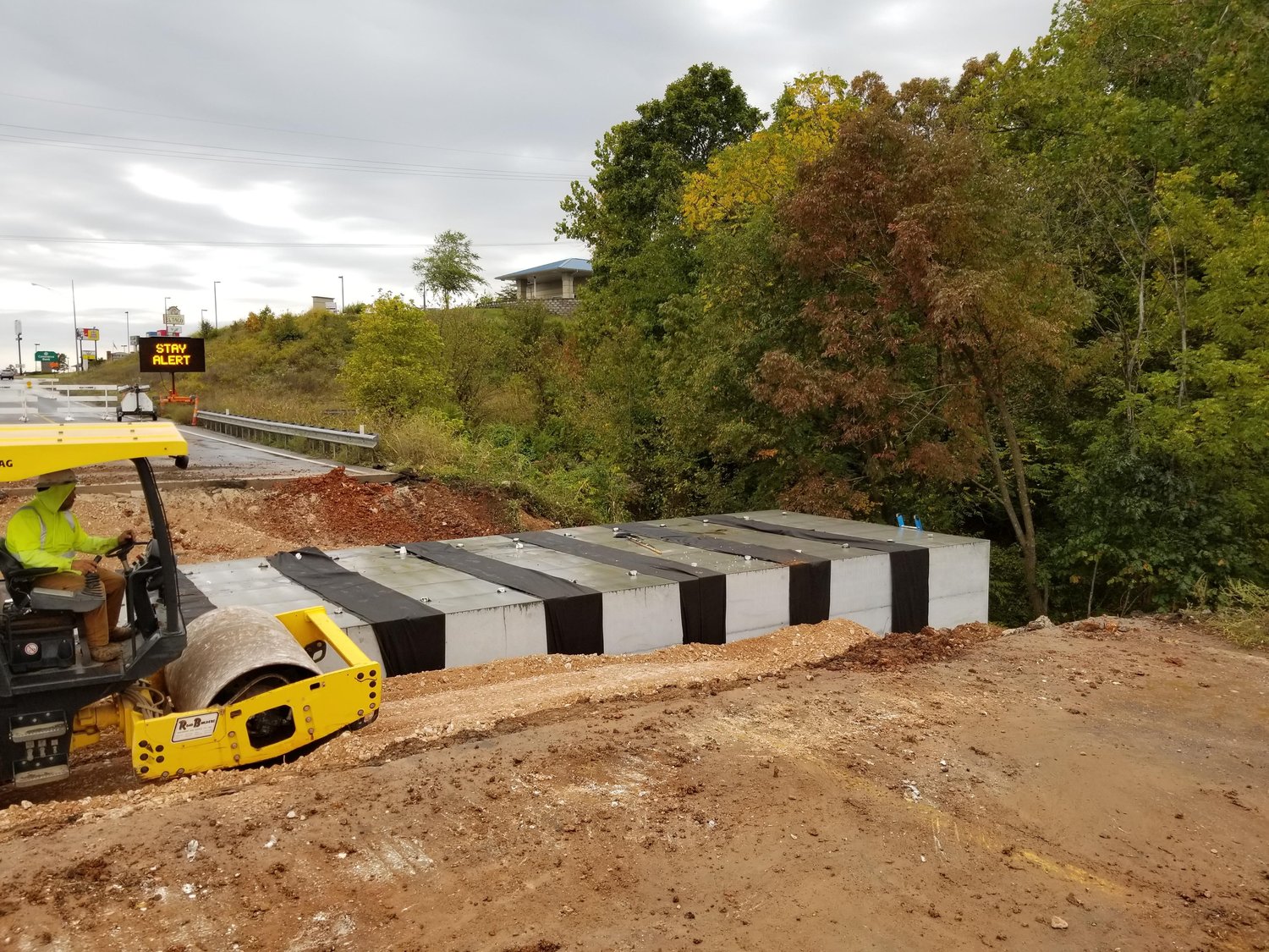 UNDERPASS PLACEMENT: Crews with Emery Sapp & Sons Inc. install a pedestrian underpass on Jackson Street in Ozark.